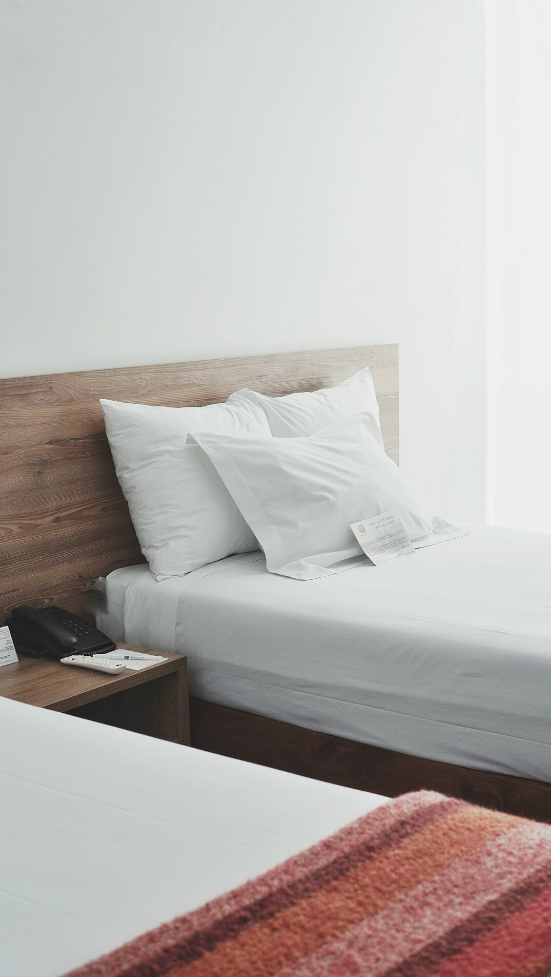 Clean modern hotel room with a double bed and window