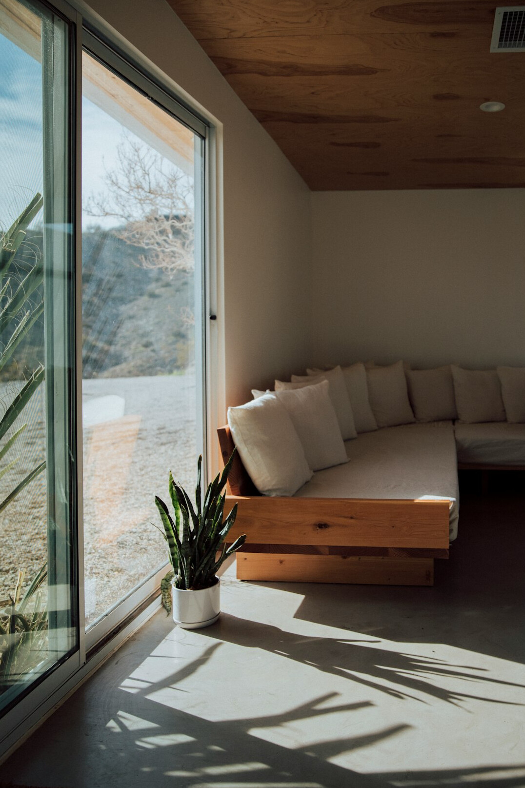 Bright holiday apartment living room with sofa and large window